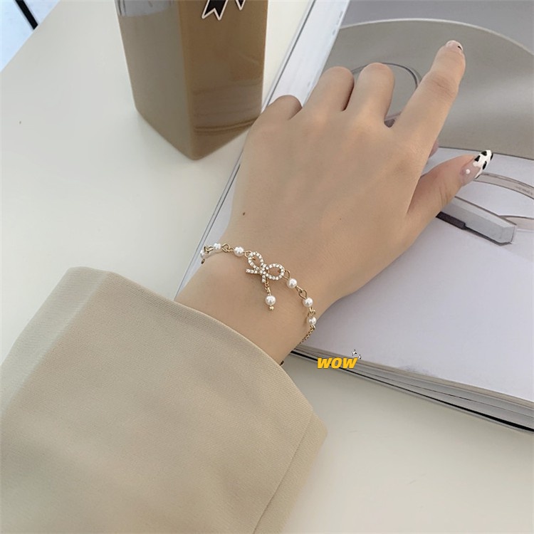 Vòng tay mạ vàng họa tiết nơ đính ngọc trai giả xinh xắn cho nữ OUYOU