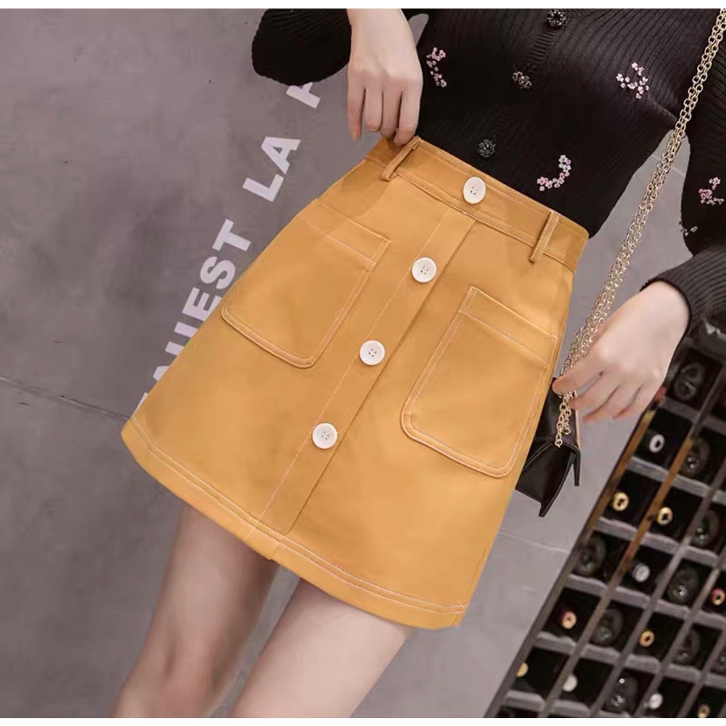 Chân váy lưng cao dáng chữ A ngắn viền chỉ nổi phối cúc có quần chống lộ trong phong cách PT8X