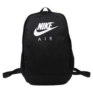 The plain color backpack features a unique Nike logo motif