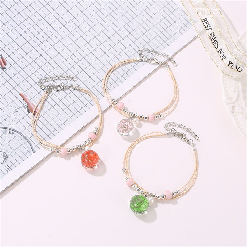 The aqua sphere shaped accessory bracelet contains lovely Korean style dried flowers