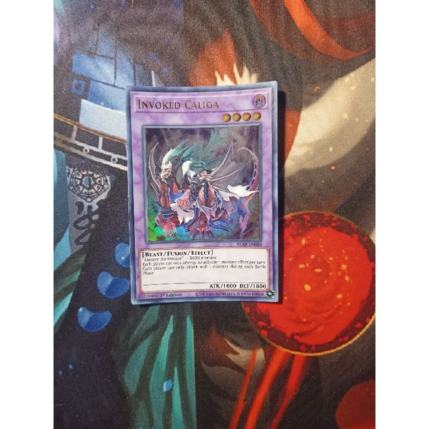 Thẻ bài Yugioh chính hãng Invoked Caliga - BLAR-EN080 - Ultra Rare 1st Edition