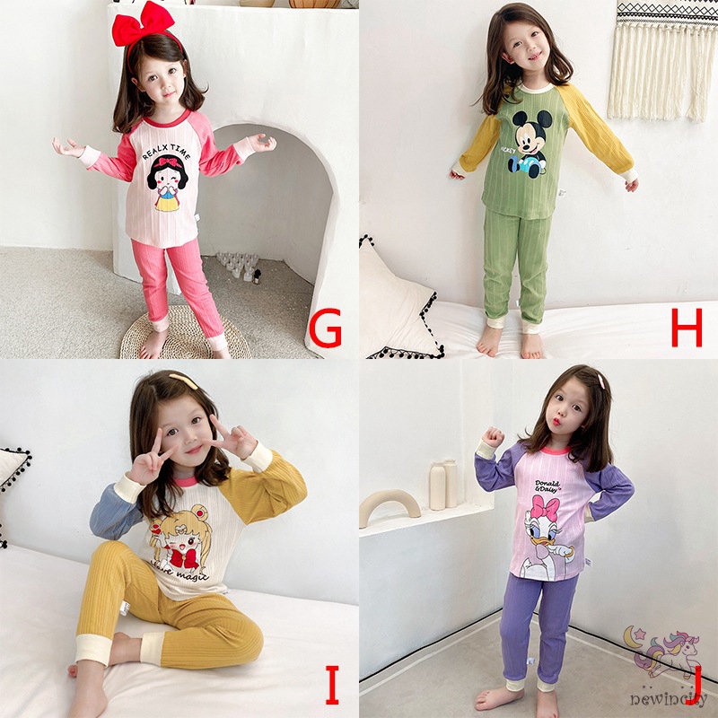 Bộ trang phục gồm áo và quần bó sát lưng cao họa tiết hoạt hình màu tươi sáng kiểu dáng Hàn Quốc thoải mái cho bé gái