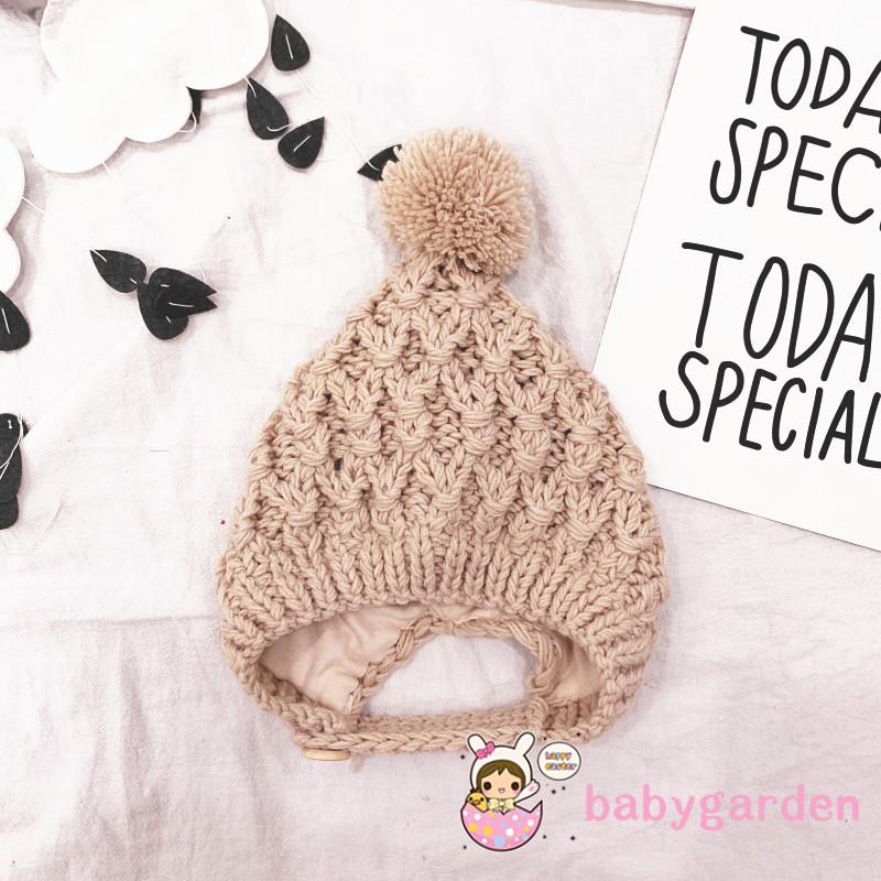 Mũ len trùm tai màu trơn có quả bông dễ thương cho trẻ em