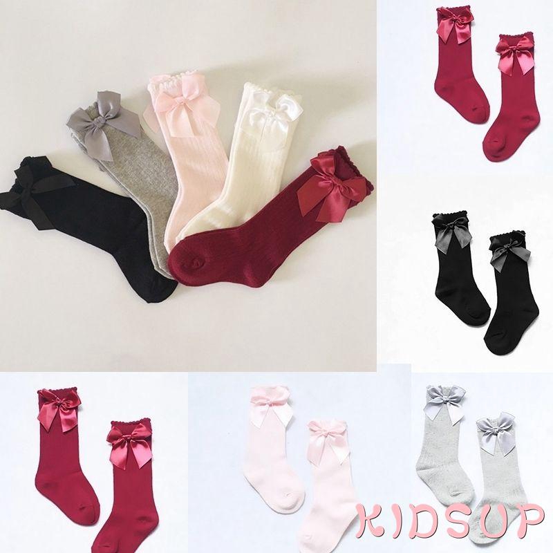 Đôi tất cotton dài mềm mại màu trơn trang trí nơ bướm xinh xắn cho bé gái