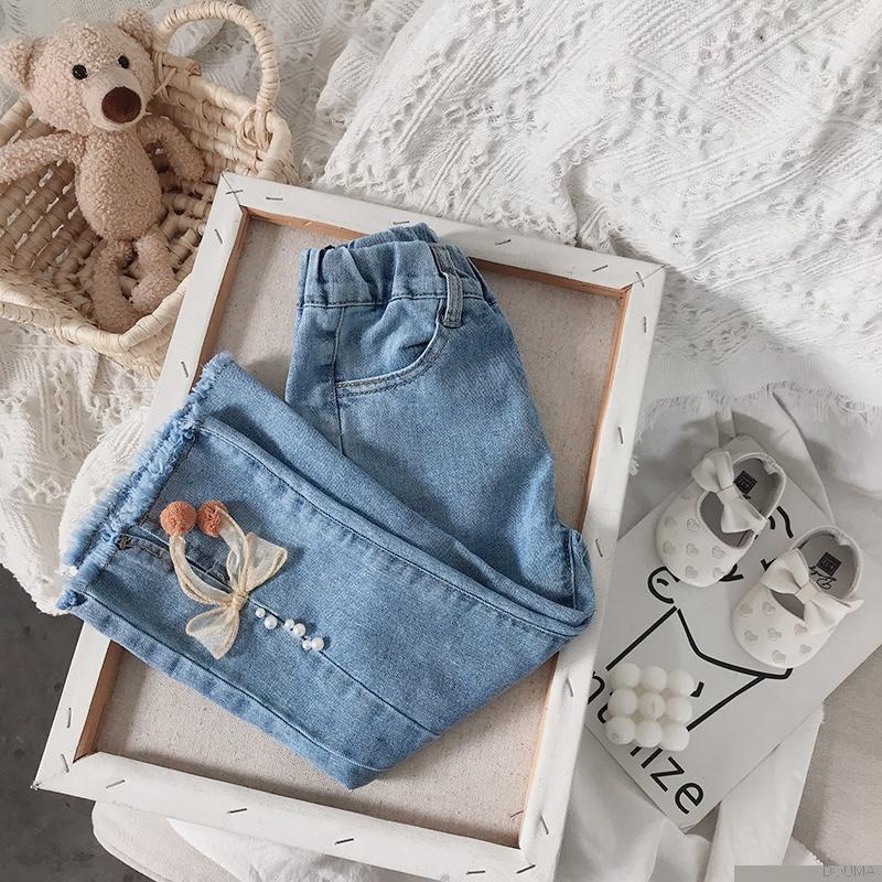 Quần jeans ống loe đính nơ thời trang cho bé gái