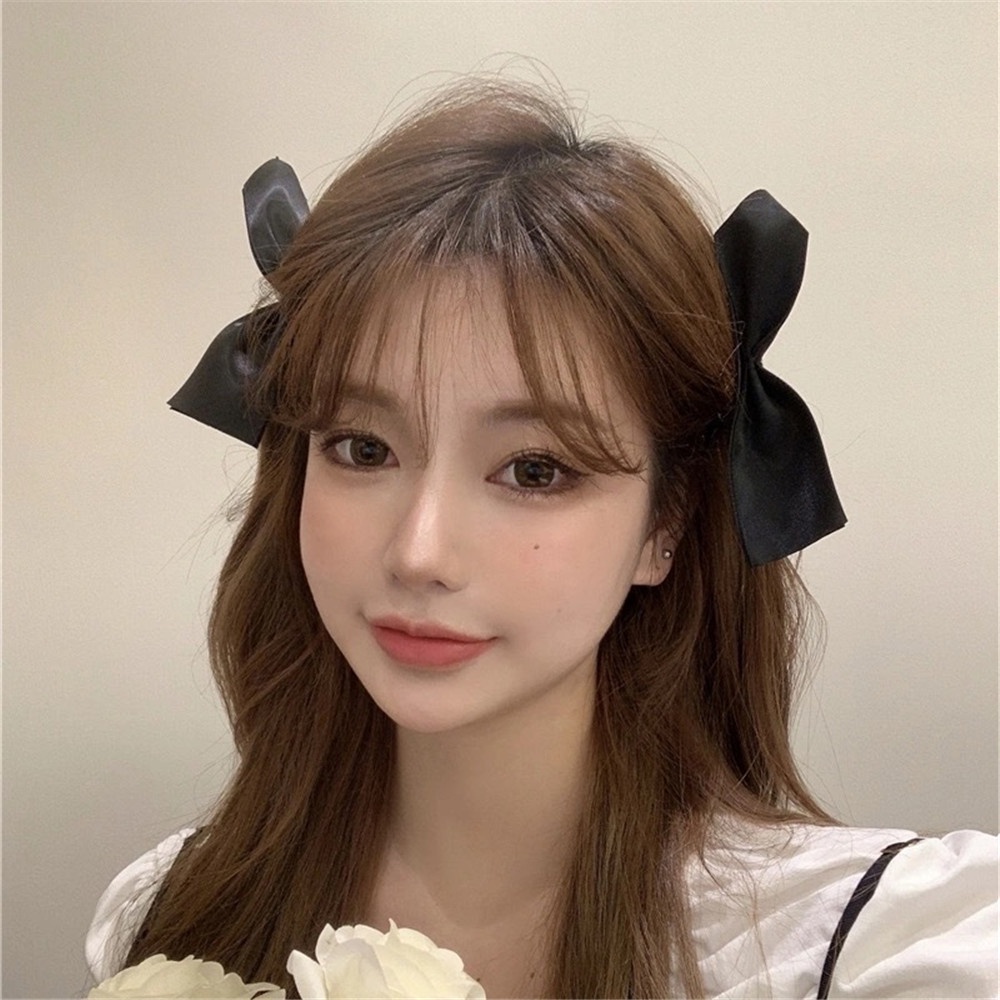 Kẹp tóc nơ có màu đen kiểu dáng thời trang