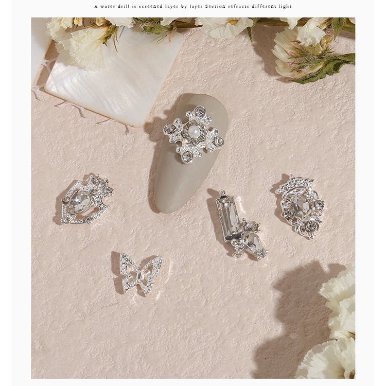 Hợp kim trang sức móng tay mới giả vỏ rhinestone nơ ngọc trai nhật bản siêu flash thả mặt dây chuyền trang sức móng tay hy4552