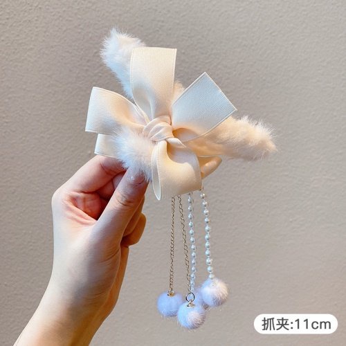 Kẹp gấp tóc nhung nơ tua rua