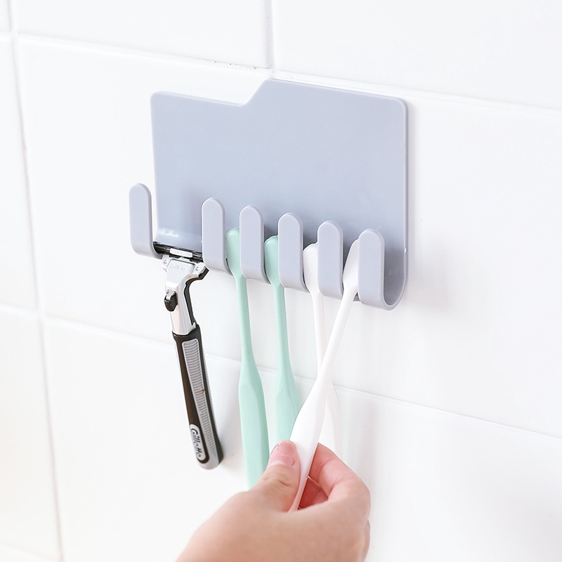 Handy wall mounted toothbrush/toothpaste/razor holder