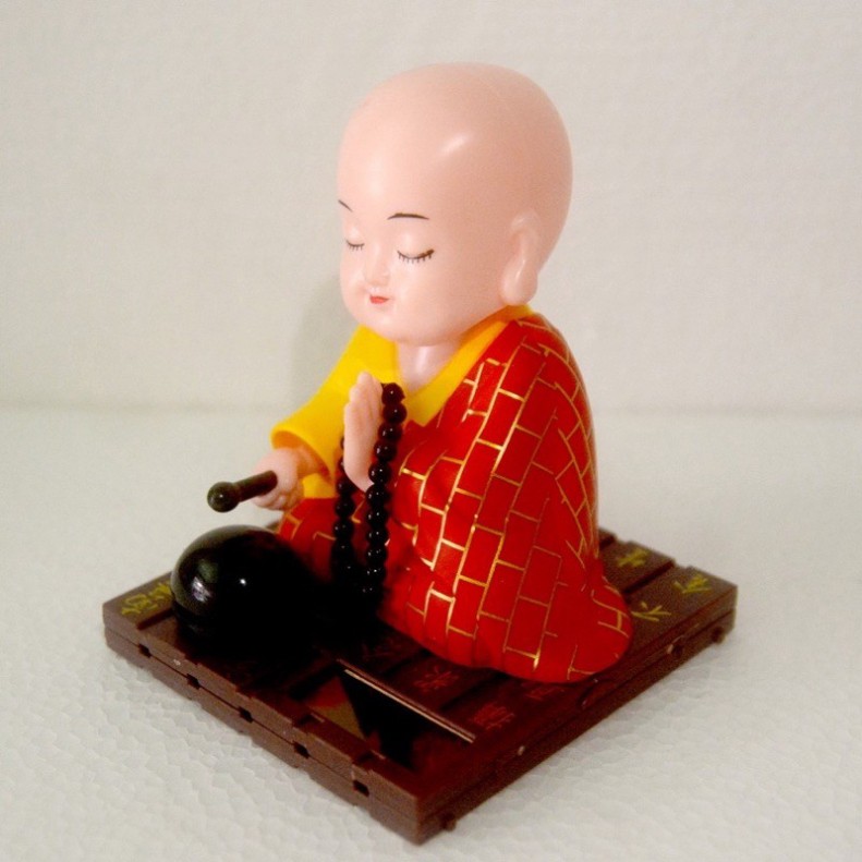 Tượng chú tiểu gõ mõ đầu gật gù tụng kinh . .