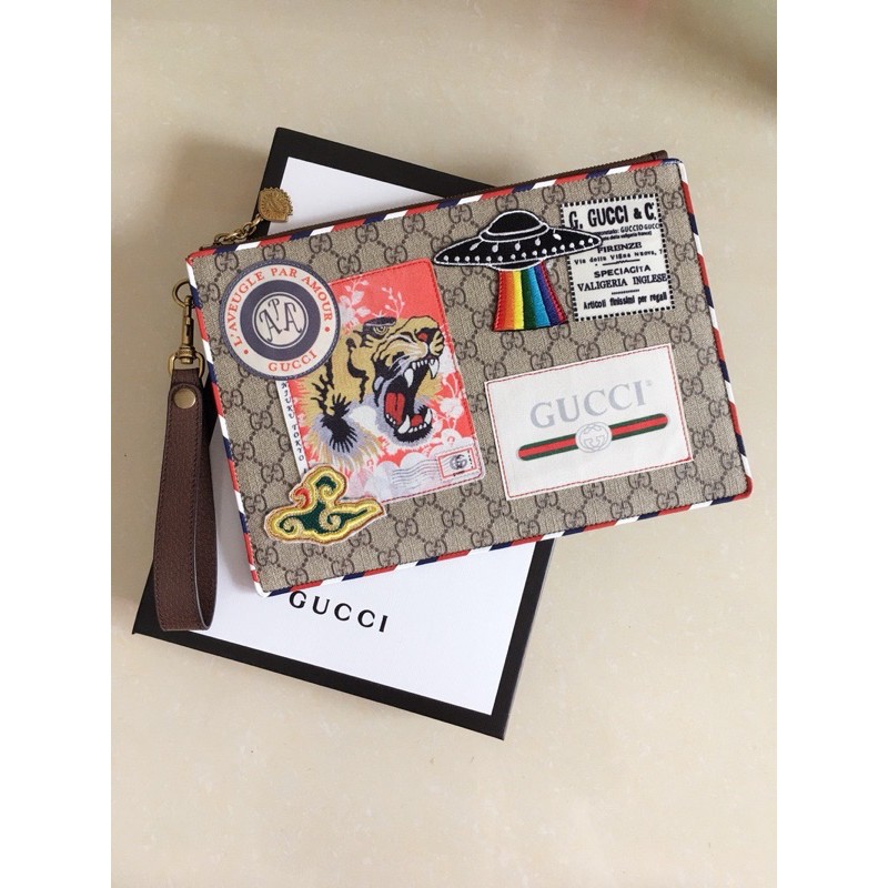 Clutch cầm tay hiệu Gucci GG da thật cao cấp có đính nhiều sticker