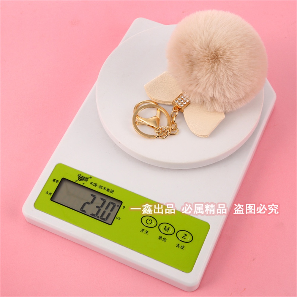 Móc Khóa Quả Cầu Lông Xù Đính Nơ Dễ Thương