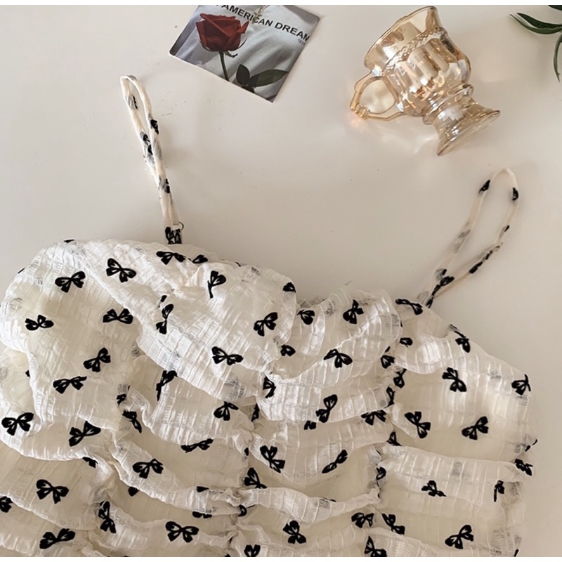 Set váy hai dây hình nơ dáng xòe và áo khoác cardigan thắt nơ đen xinh xắn