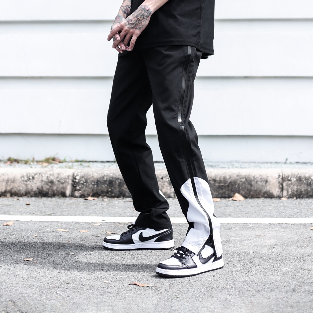 Quần Thun Có Zipper Khóa Sọc Trắng Chất Liệu Vải Dù Ống Rộng Form Unisex Màu Đen