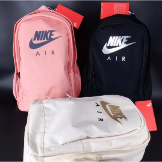 The plain color backpack features a unique Nike logo motif
