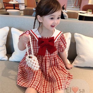Váy caro đính kèm nơ đỏ bé gái