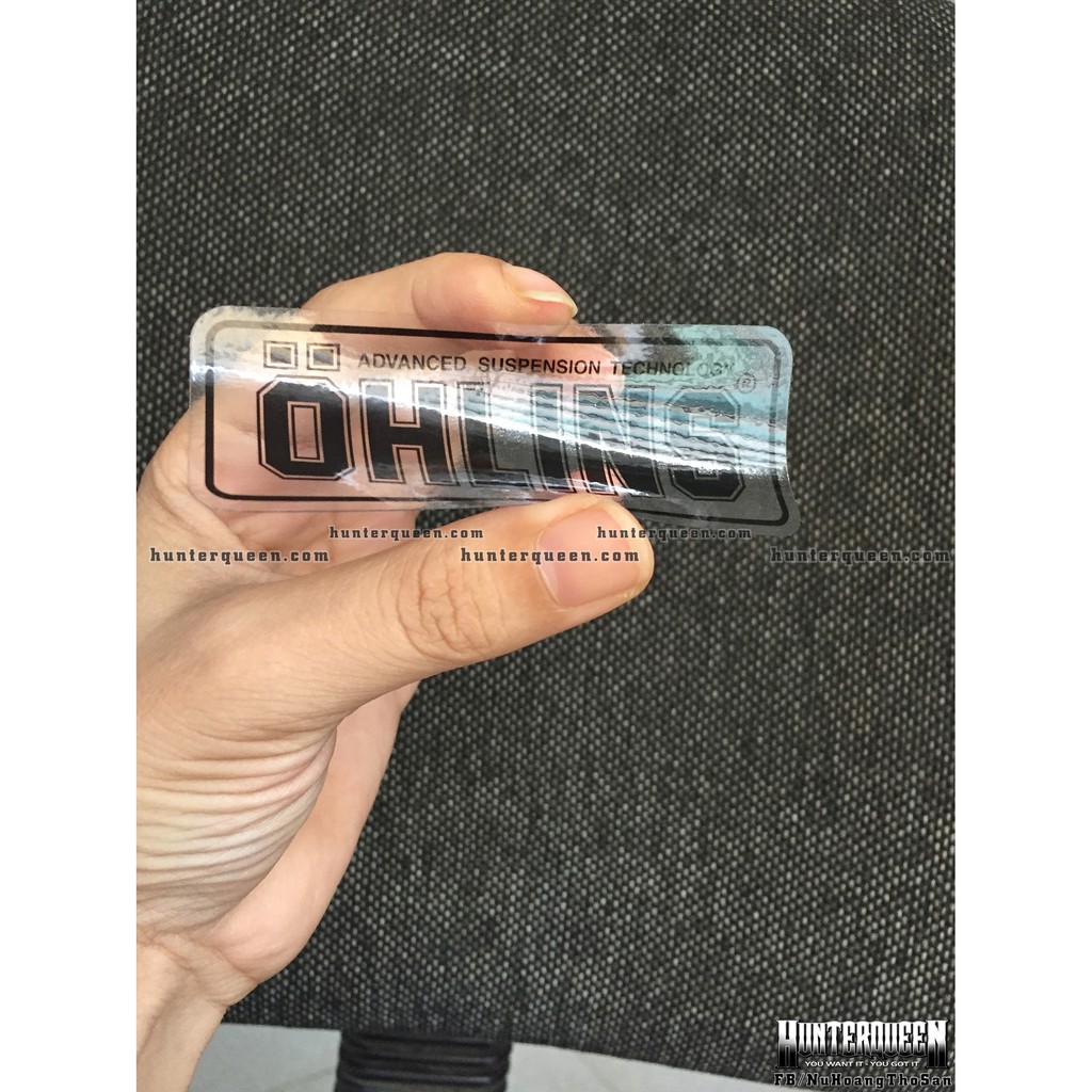 Logo Oh-Lins[9x3.7cm] trong suốt. Nền xuyên thấu, chữ đen. Hình dán decal siêu dính, chống nước, tem đua trang trí