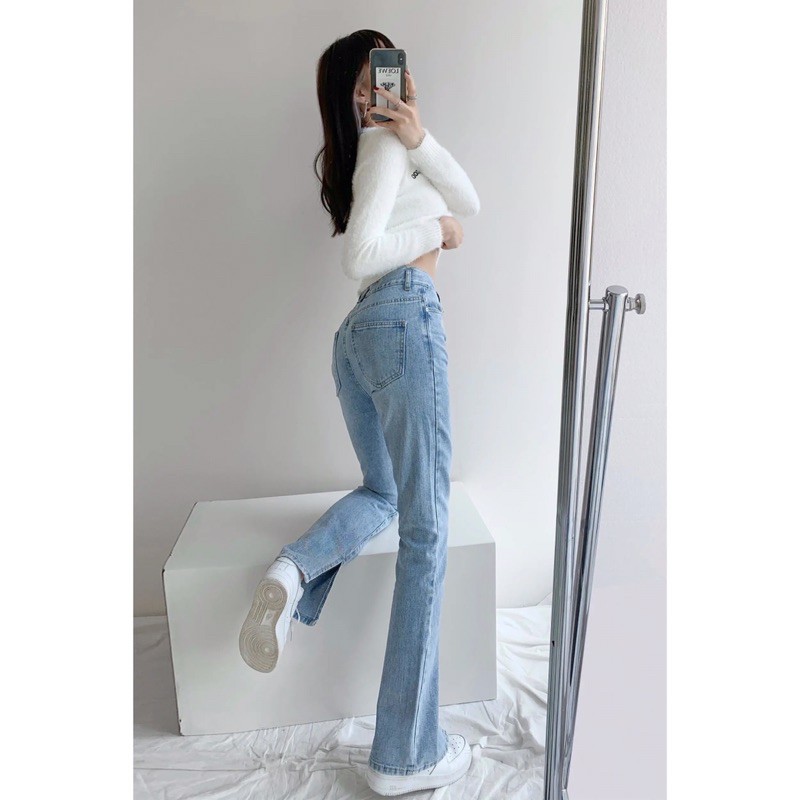 Quần jeans nhạt ống loe xẻ gấu