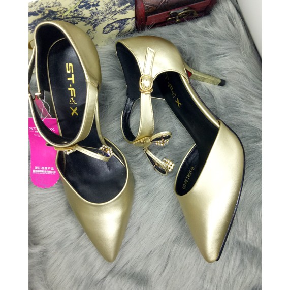 Giày cao gót mũi nhọn gót nhọn màu ánh đồng cao 7 cm, dây quanh cổ chân có đính nơ đá vuông