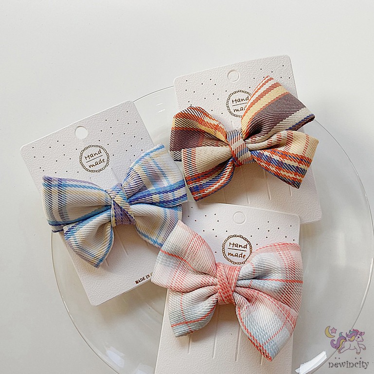 Kẹp tóc đính nơ kẻ sọc ca rô xinh xắn dành cho bé gái