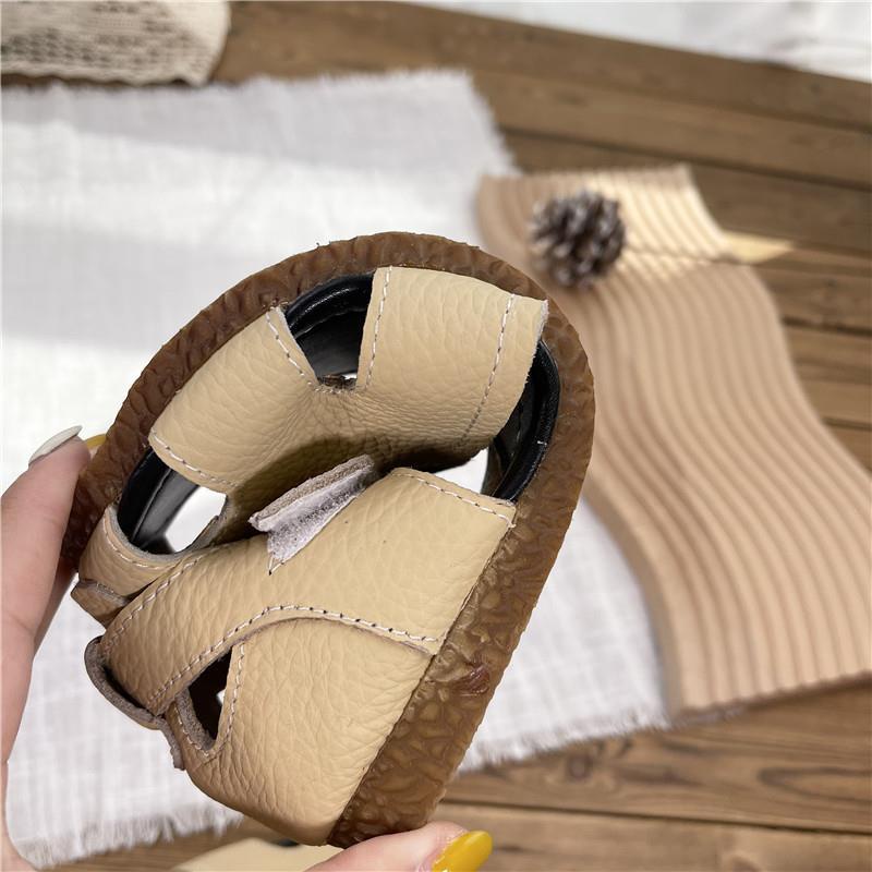 Xăng đan Da Đế Bằng Mũi Tròn Khoét Lỗ Phong Cách Roman Cho Nữ