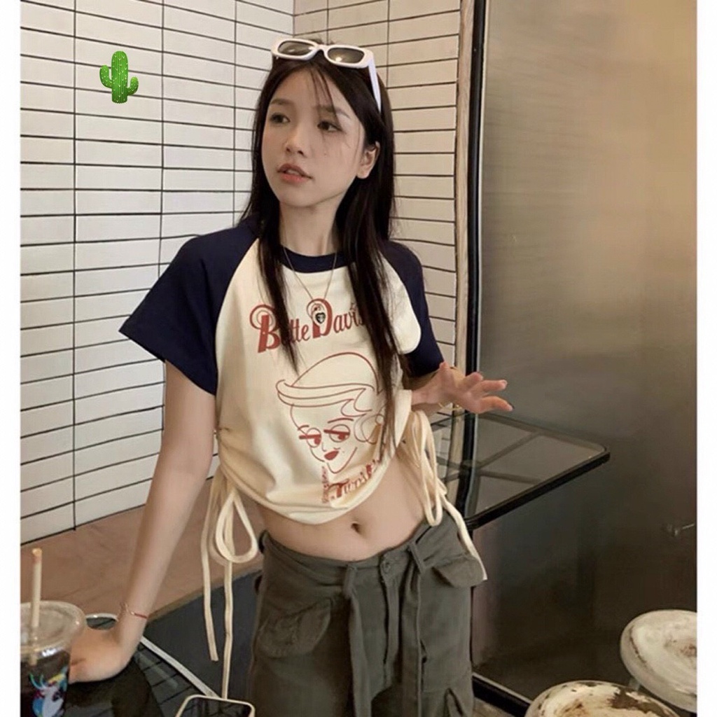 Áo kiểu croptop màu kem tay xanh in chữ logo trước rút dây 2 bên cực xinh , chất thun bozip mềm mịn