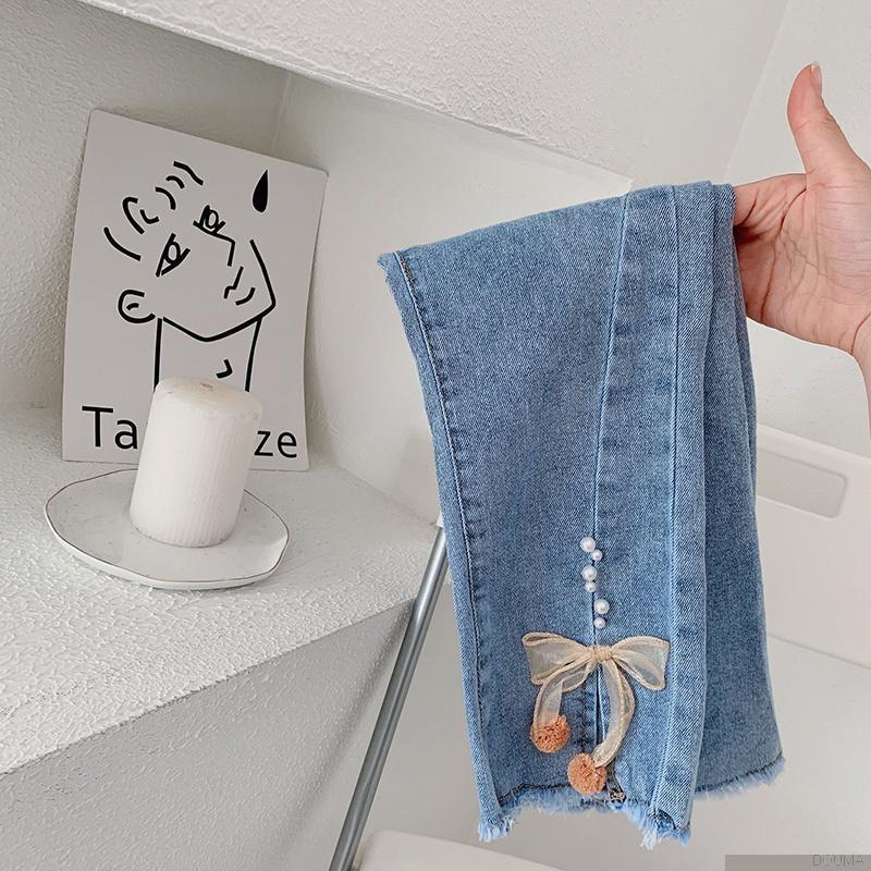 Quần jeans ống loe đính nơ thời trang cho bé gái