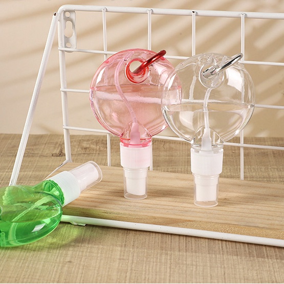 1 chai xịt hình tròn kèm móc khóa bằng nhựa màu sắc ngẫu nhiên