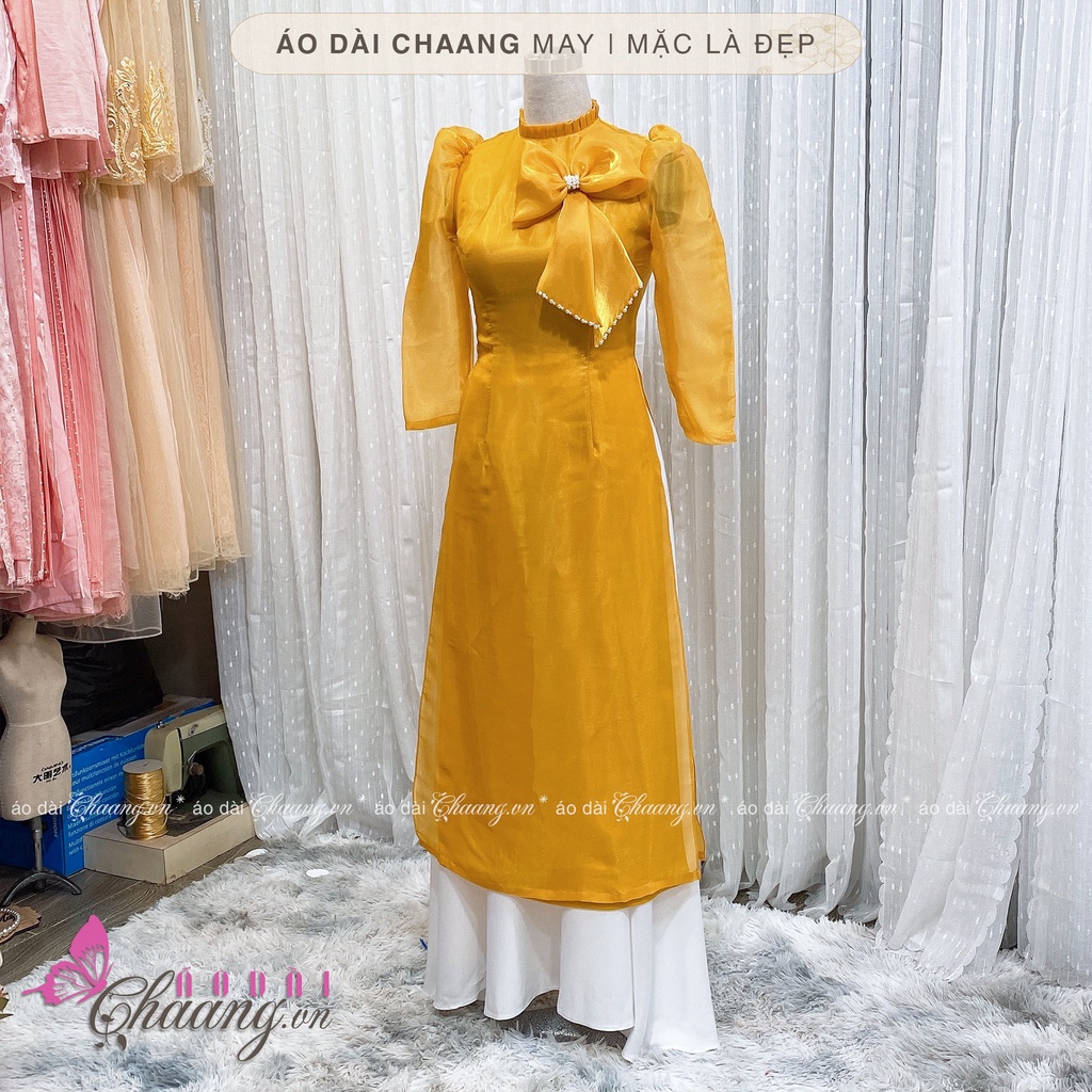 Áo Dài Cách Tân Nữ 4 Tà Lụa Tơ Sống Vàng Cổ Bèo Vai Bồng Đính Nơ Ngọc Đẹp CTV020