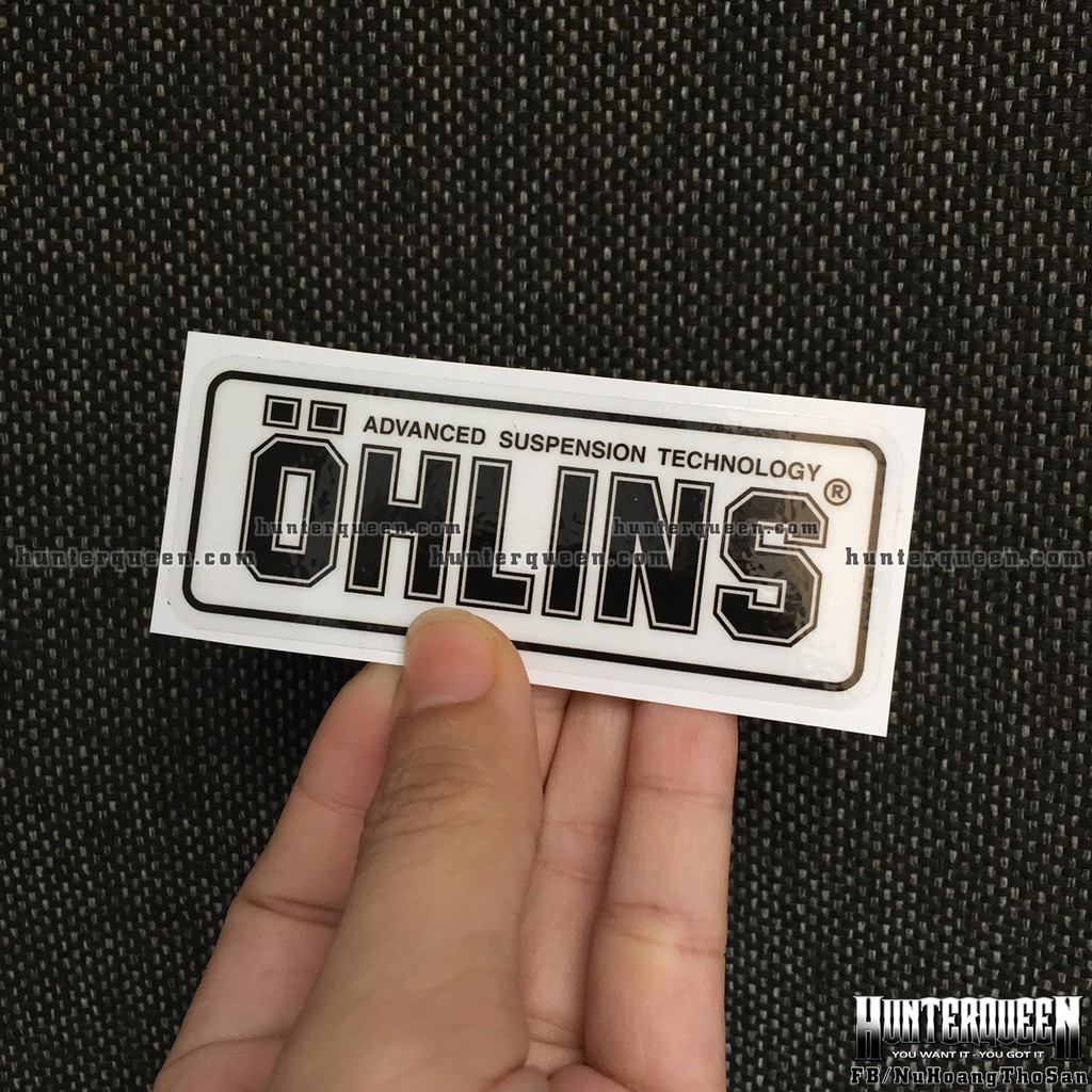 Logo Oh-Lins[9x3.7cm] trong suốt. Nền xuyên thấu, chữ đen. Hình dán decal siêu dính, chống nước, tem đua trang trí