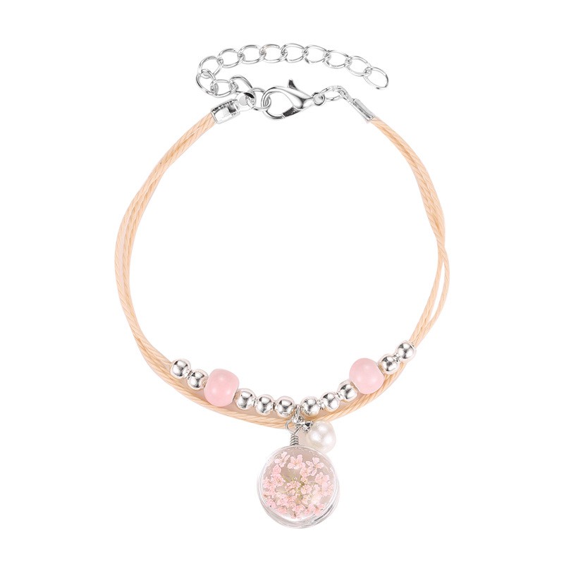 The aqua sphere shaped accessory bracelet contains lovely Korean style dried flowers