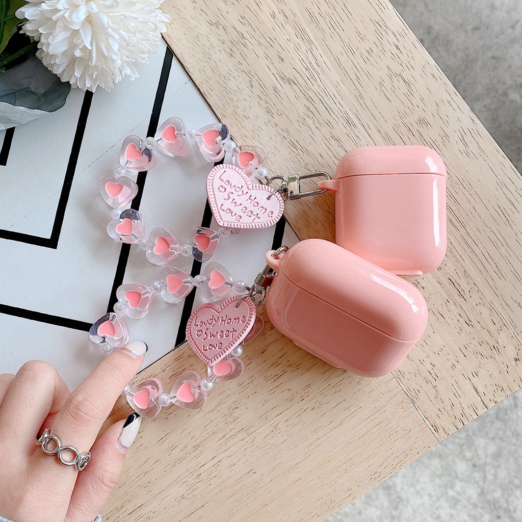 Vỏ bảo vệ hộp sạc tai nghe bluetooth airpods 1 / 2 bằng tpu mềm hình kẹo trái tim màu hồng có dây đeo chống thất lạc