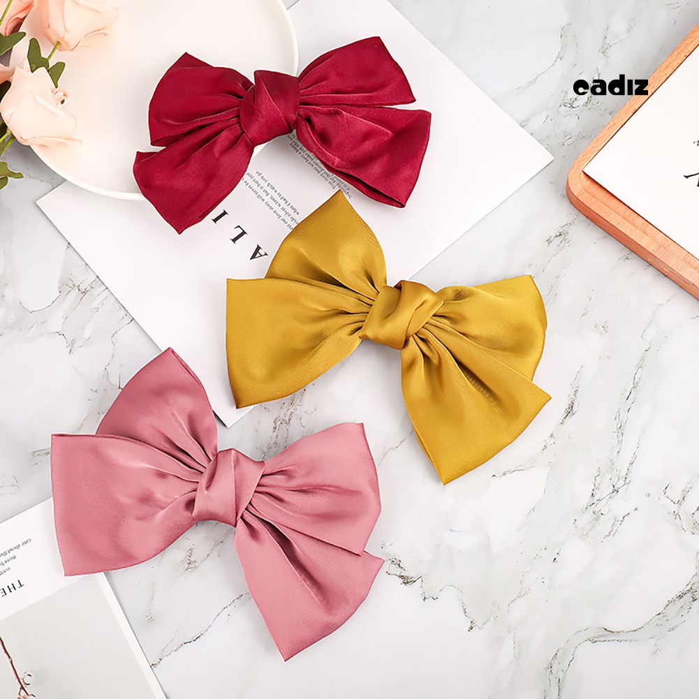 Kẹp tóc nơ màu trơn xinh xắn đáng yêu