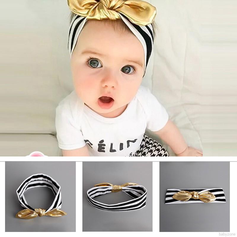 Băng đô vàng đính nơ xinh xắn cho bé gái