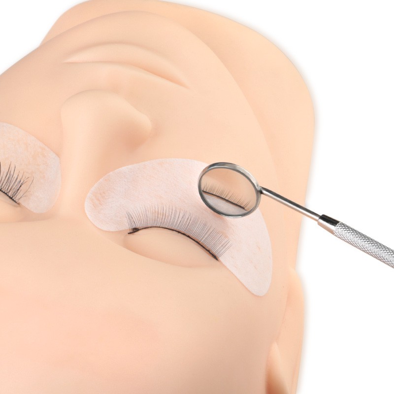 Một gương răng thép không gỉ để kiểm tra sự giãn nở lông mi bằng thiết bị in Mi-Press.