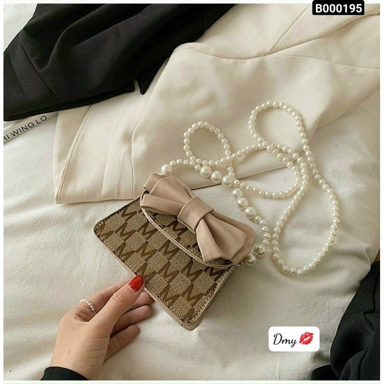 Túi xách gắn nơ quai ngọc