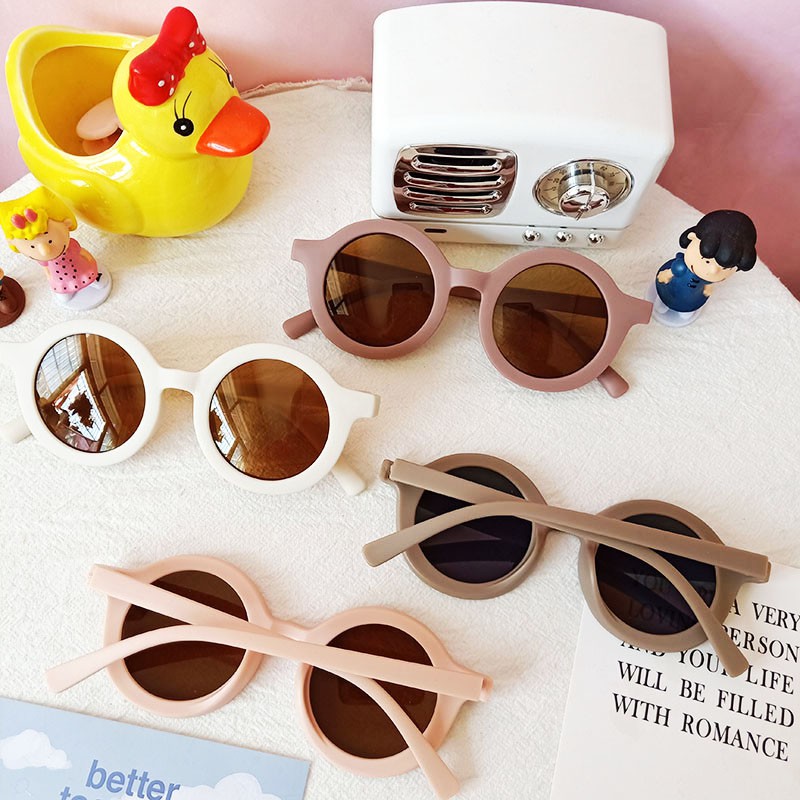 Kính mát gọng tròn chống tia cực tím màu trơn đáng yêu cho bé