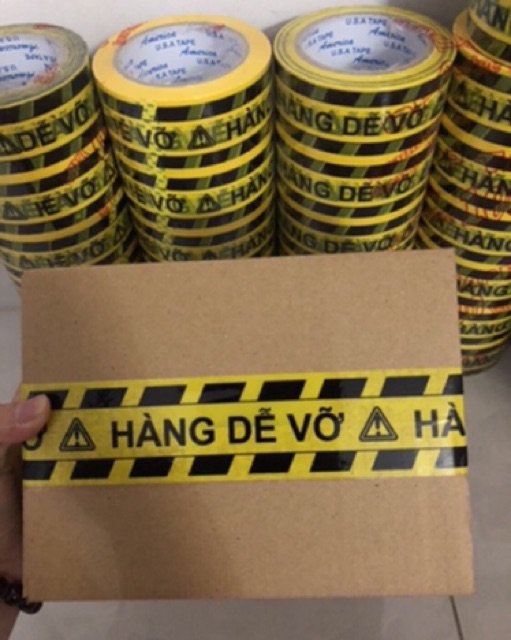 1 cây (6 cuộn)Băng Keo Niêm Phong in chữ &quot;HÀNG DỄ VỠ&quot; giá sỉ hàng sẵn