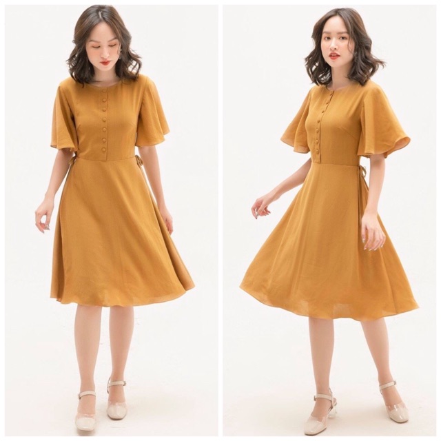 Đầm vàng nghệ nơ eo