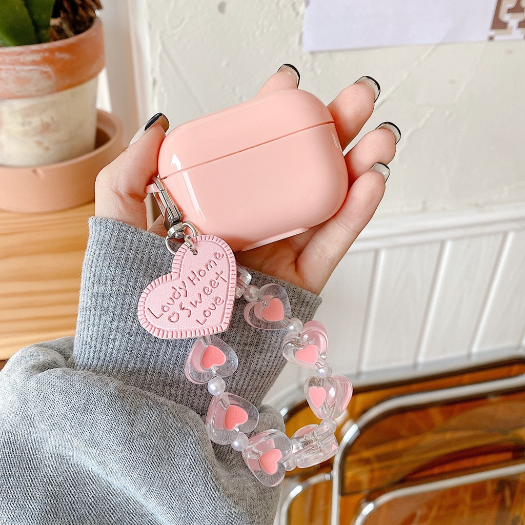 Vỏ bảo vệ hộp sạc tai nghe bluetooth airpods 1 / 2 bằng tpu mềm hình kẹo trái tim màu hồng có dây đeo chống thất lạc