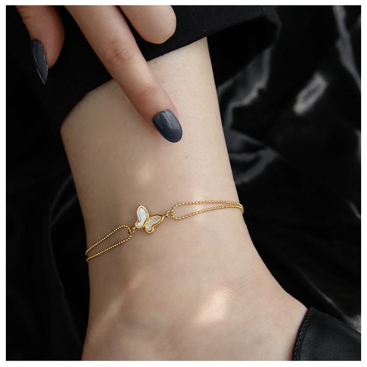 Lắc chân titan dây bi phối mặt hình bướm cẩm xà cừ không gỉ