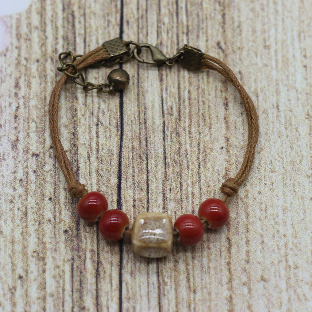 VT28 Vòng tay hạt gốm mix charm 5 cái/lốc