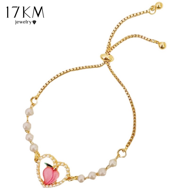 Vòng tay 17KM chuỗi hạt ngọc trai mặt trái tim rỗng màu hồng thời trang Hàn Quốc cho nữ