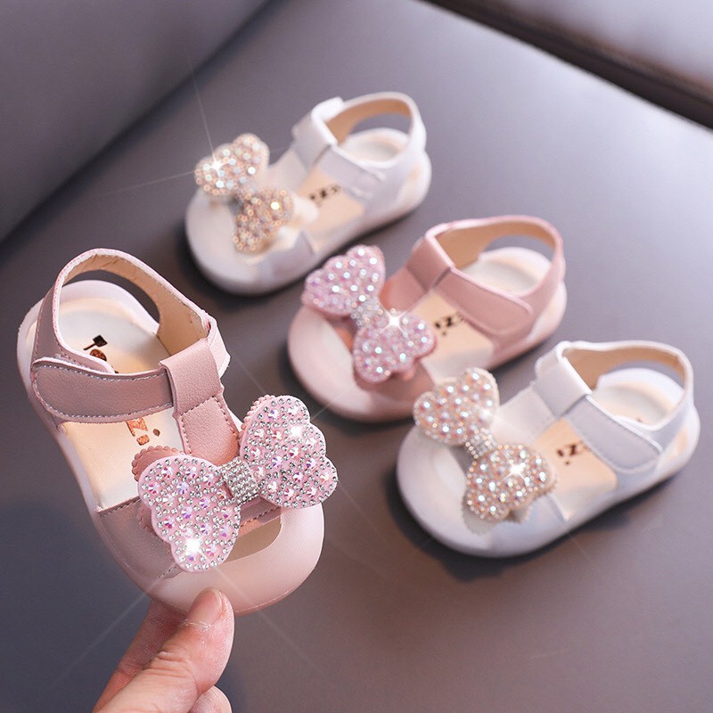 Sandal tập đi chống vấp cho bé - dép cho bé gái nơ đã lấp lánh da mềm có quai dán ôm chân, đế PU mềm 2052 ( ảnh thật)