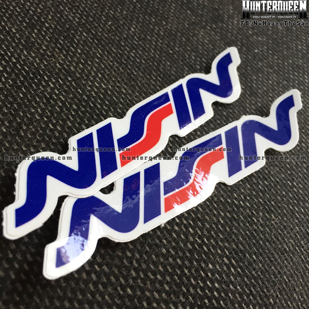 NISSIN[11.2x2cm] decal cao cấp chống nước, sắc nét, bền màu, dính chặt. Hình dán logo trang trí mọi nơi, in theo yêu cầu