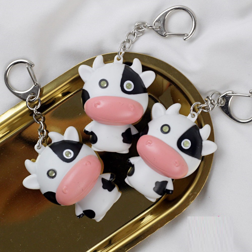 Móc khóa bò sữa mặt ngố có nhạc đèn siêu cute