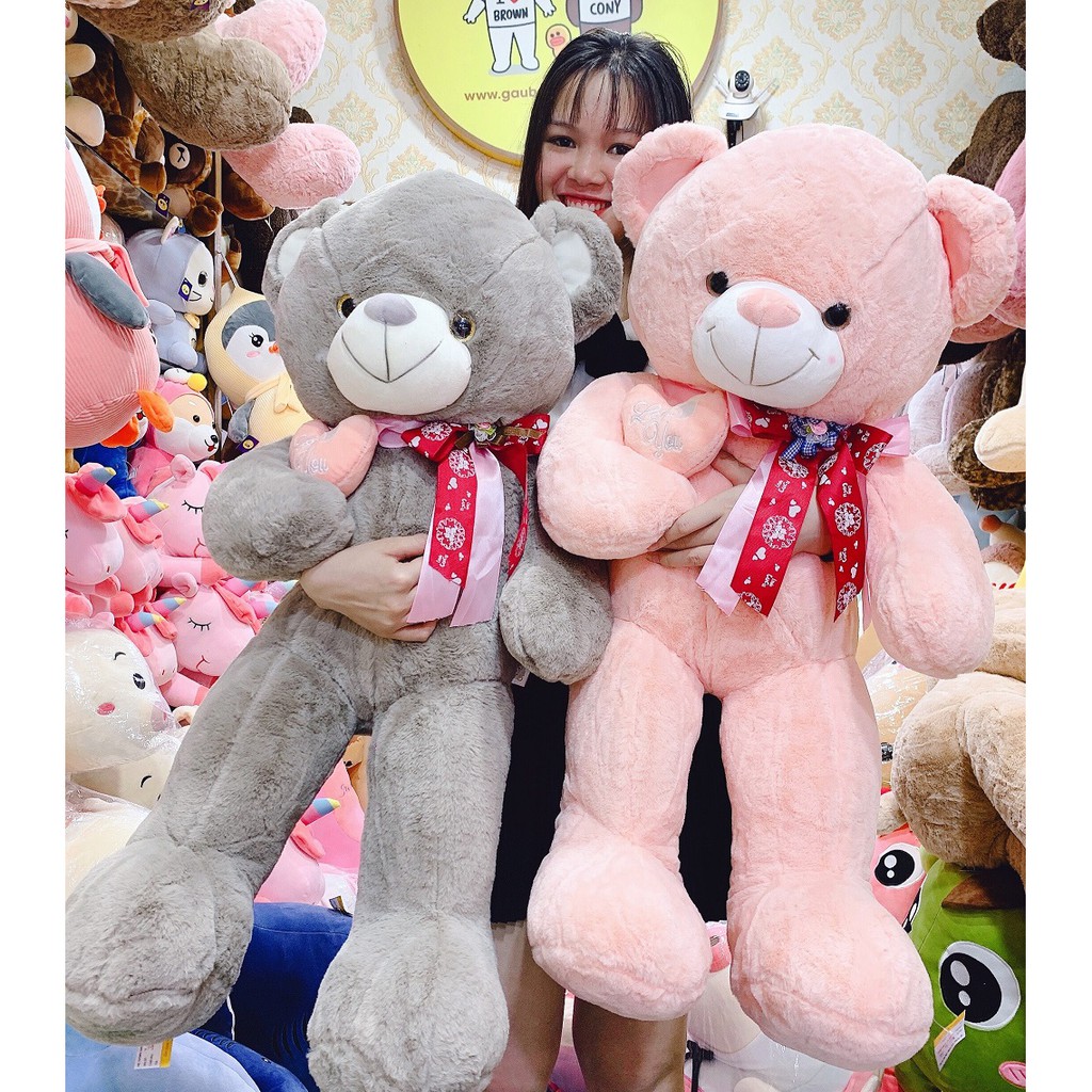 Gấu bông Teddy ôm tim lệch đeo nơ 3 màu hồng nâu ghi - Teddy Cao cấp - Xưởng Gấu Bông Việt Nam