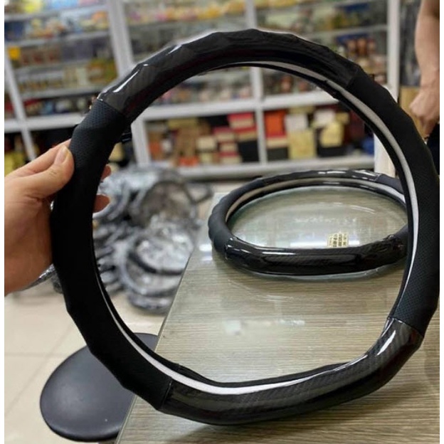 Bọc vô lăng Nissan Almera - Da vân Carbon