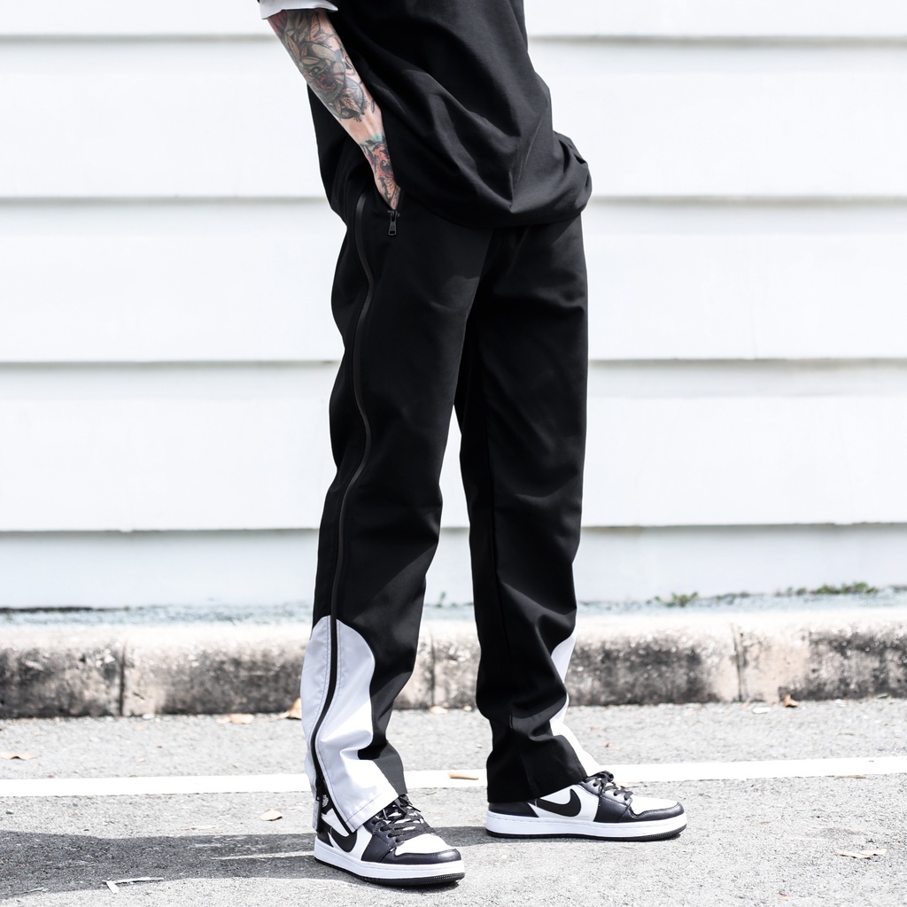 Quần Thun Có Zipper Khóa Sọc Trắng Chất Liệu Vải Dù Ống Rộng Form Unisex Màu Đen