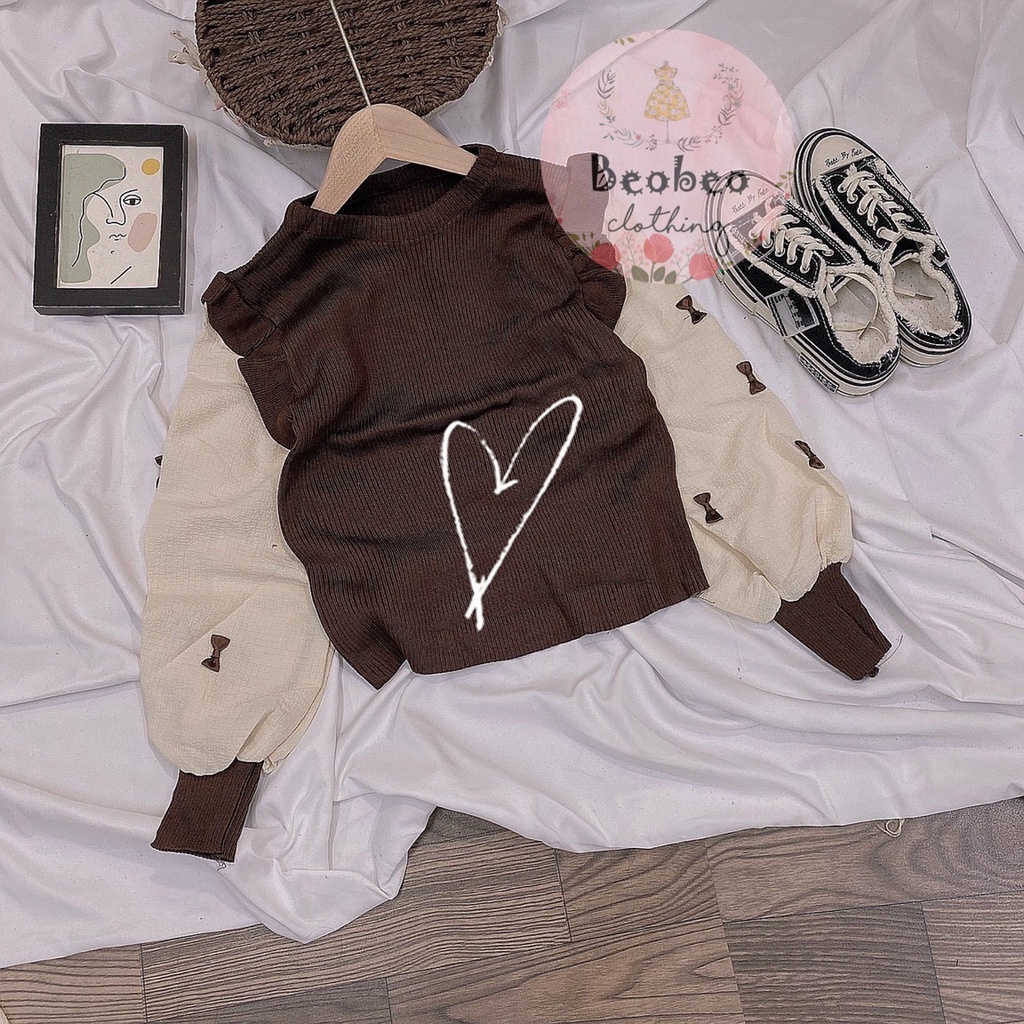 Áo len phối bèo tay phồng nude đính nơ Quảng Châu